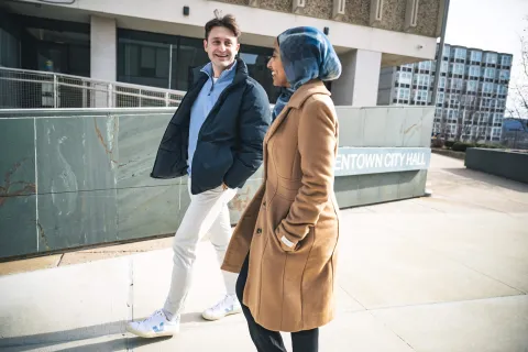 Trevor Tormann walking with Huda Hagos in Allentown. 