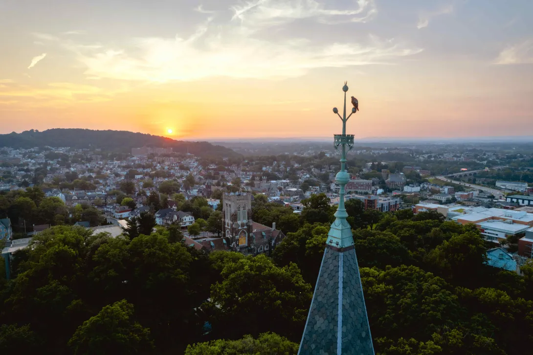 Drone view of Bethlehem at sunset showing Lehigh University campus and surrounding area