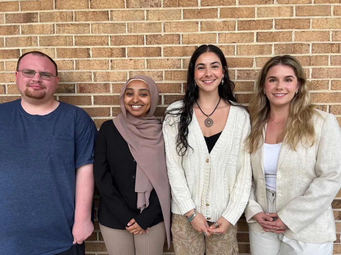 Lehigh University four Community Fellows standing next to each other in front of a brick wall.