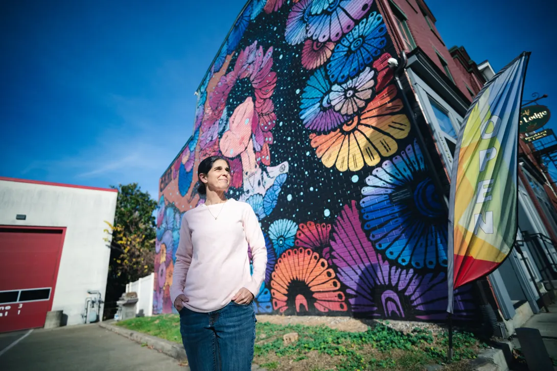 Karen Beck Pooley standing in front of a colorful mural in Bethlehem.
