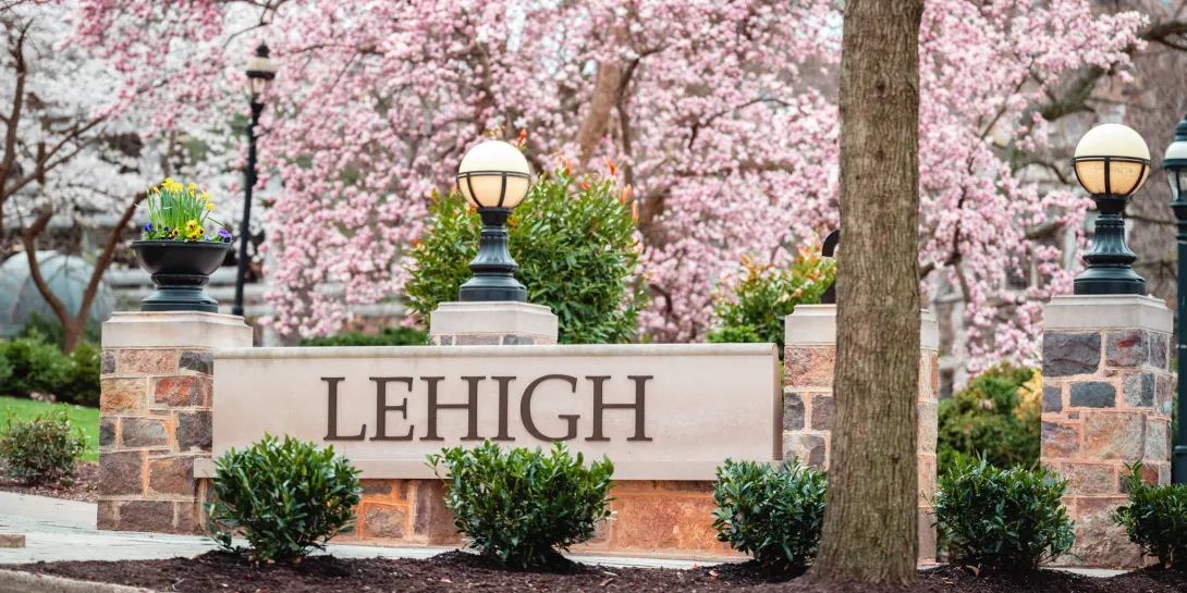 Lehigh sign with a light surrounded by cherry blossoms.